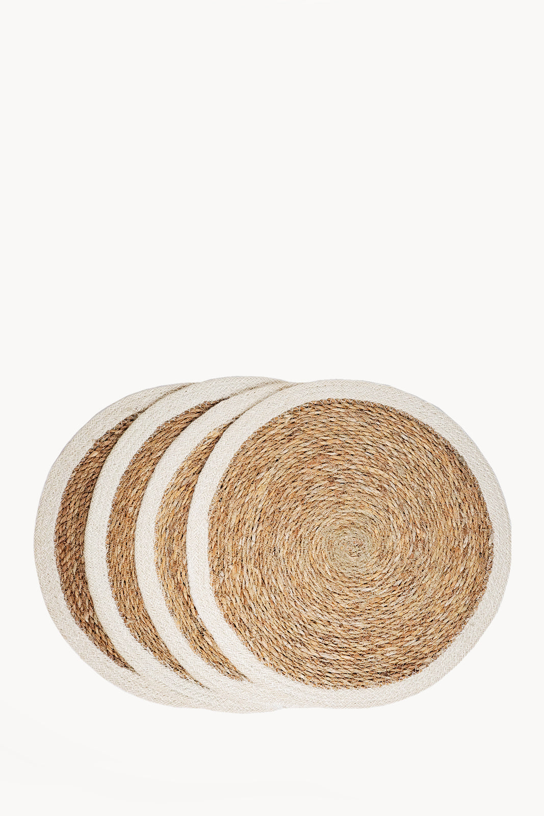 Set of four round woven coasters with natural and white borders on a white background