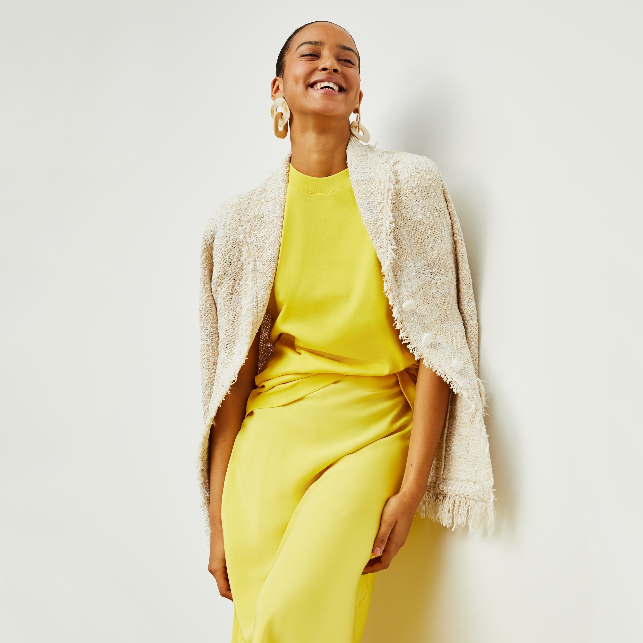 Front image of a woman standing wearing the porter jacket in taupe and ivory | Exclude