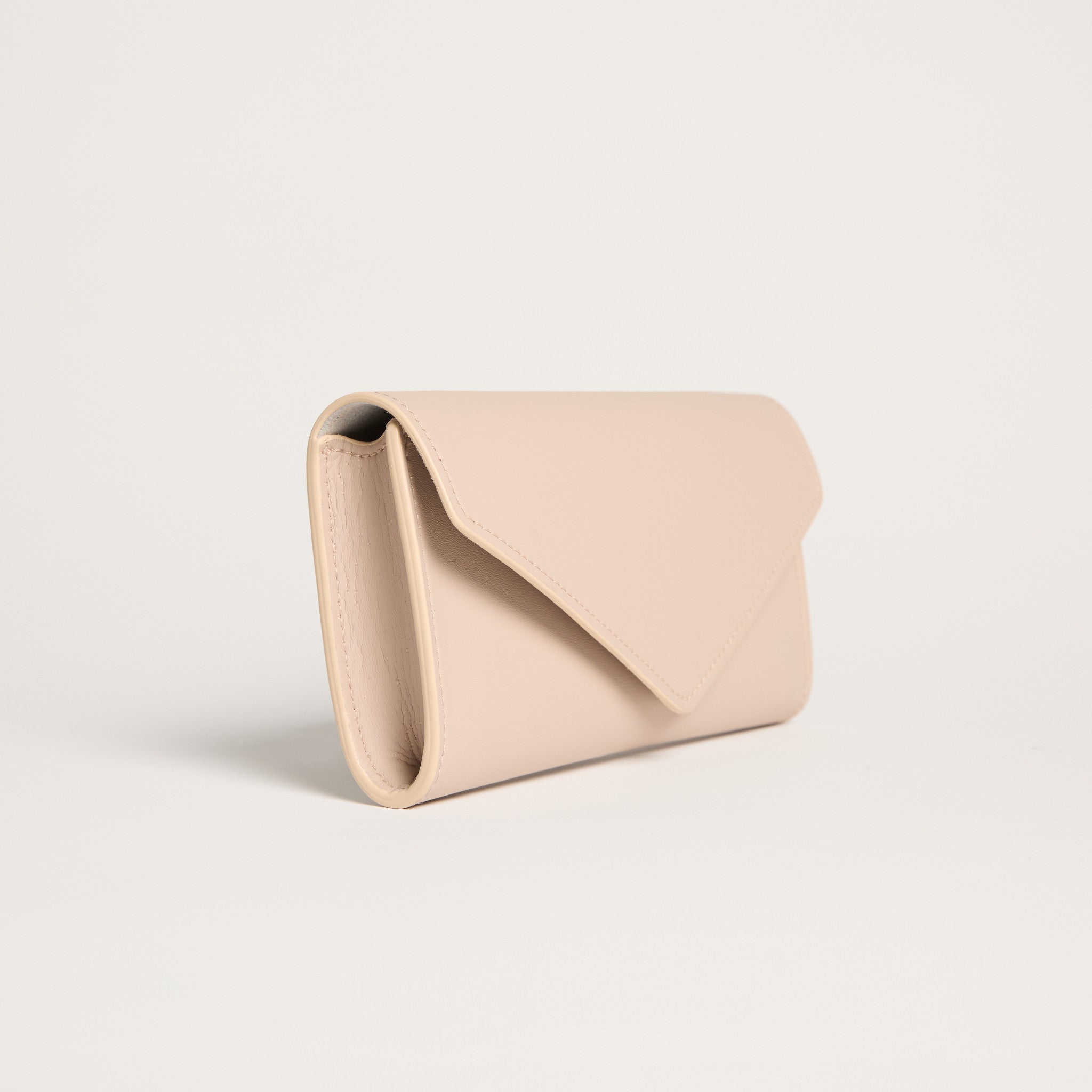 Beige clutch bag on a light beige background