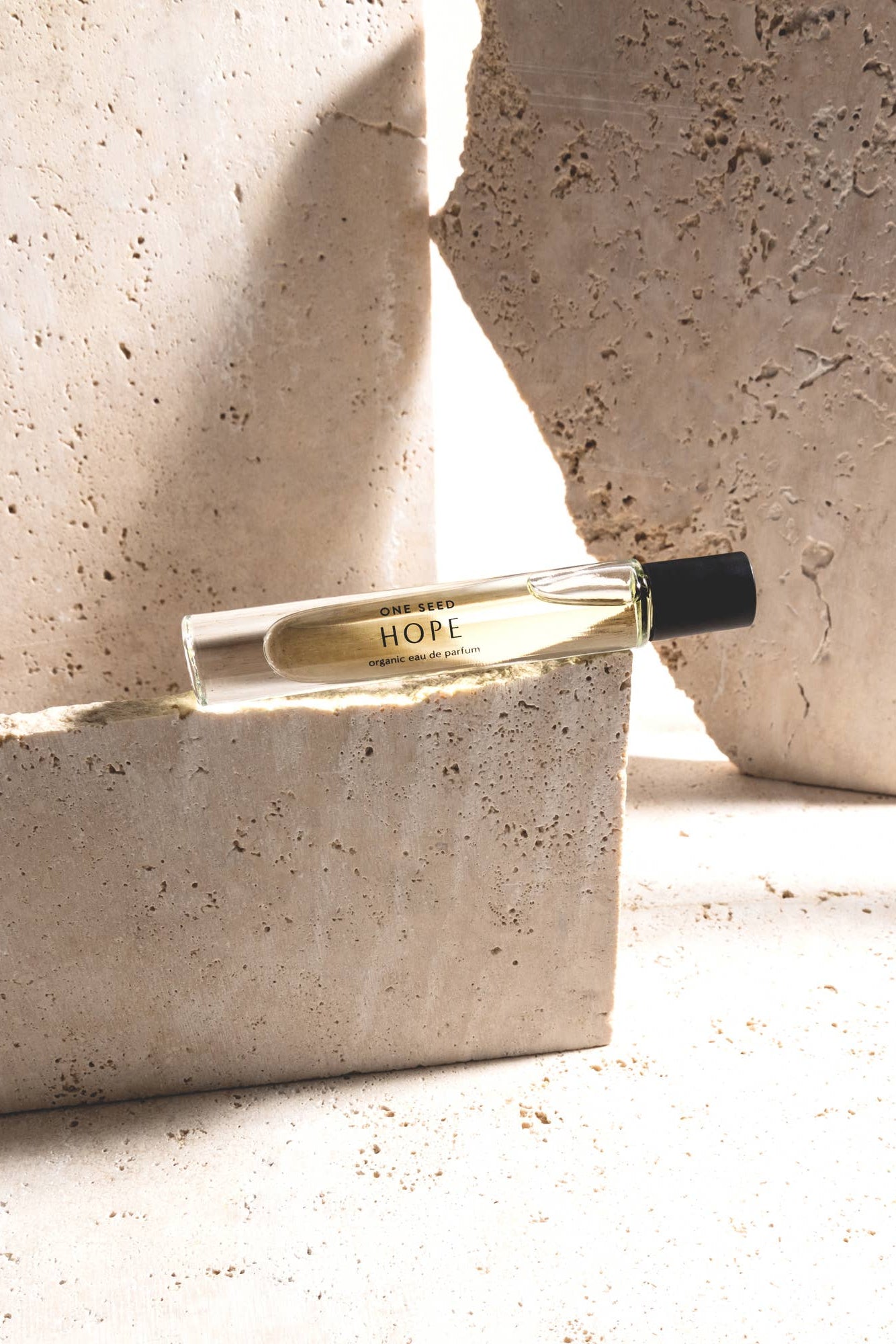 Perfume bottle labeled 'Hope' on a textured stone surface
