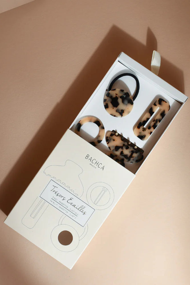 Leopard print hair ties in a 'BACHCA' branded box on a beige background