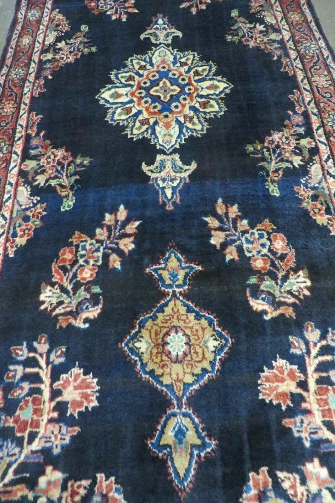 Decorative rug with intricate patterns on a dark blue background