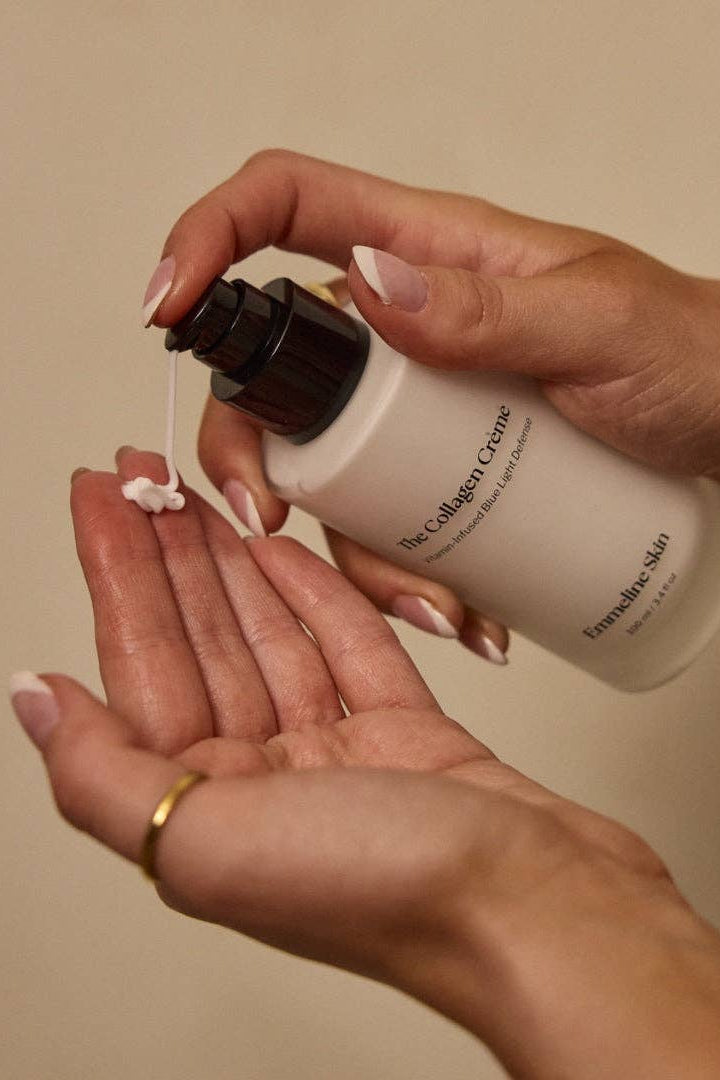 Person applying cream from a bottle labeled 'The Collagen Creme' to their hand.