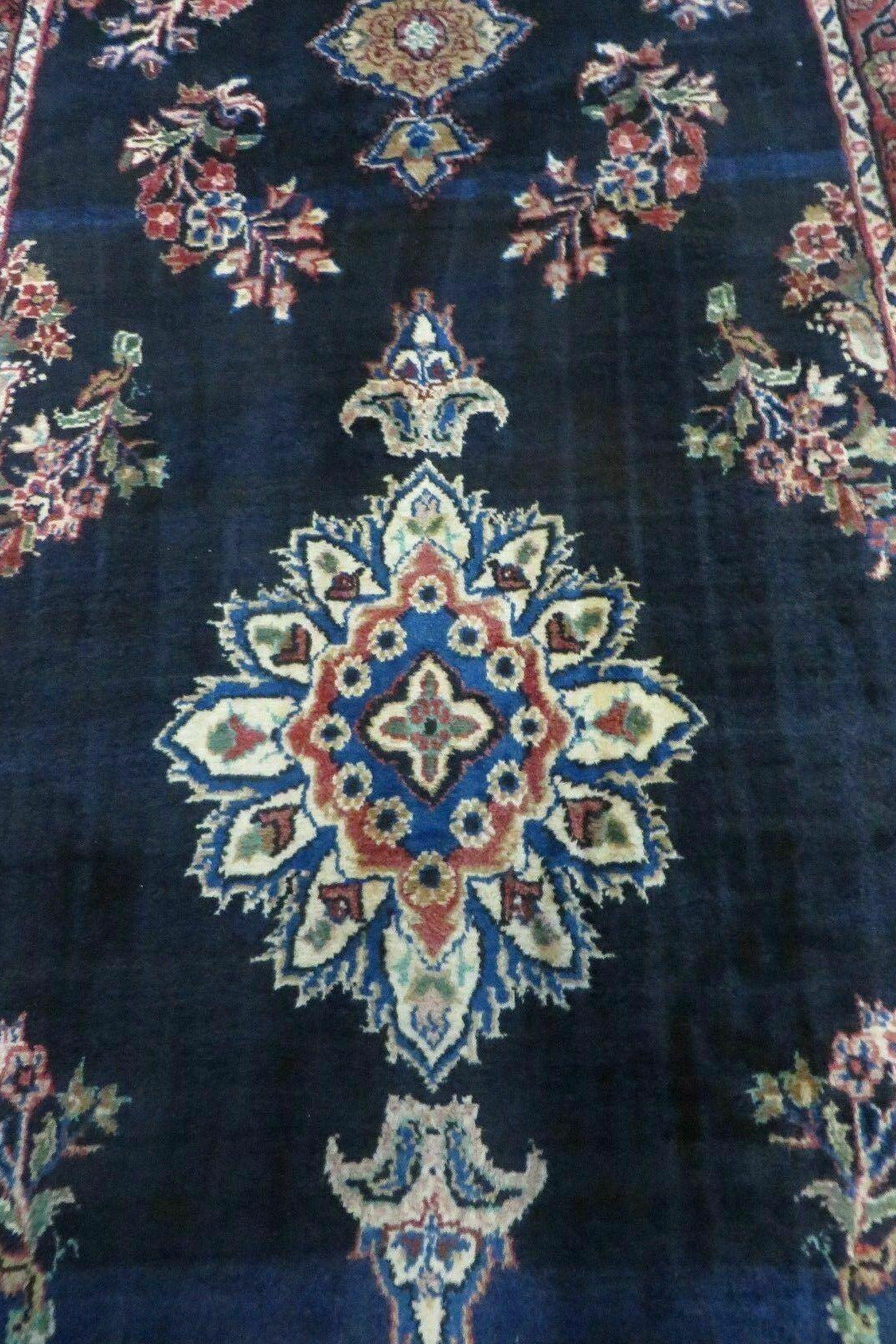 Decorative rug with intricate patterns on a dark blue background