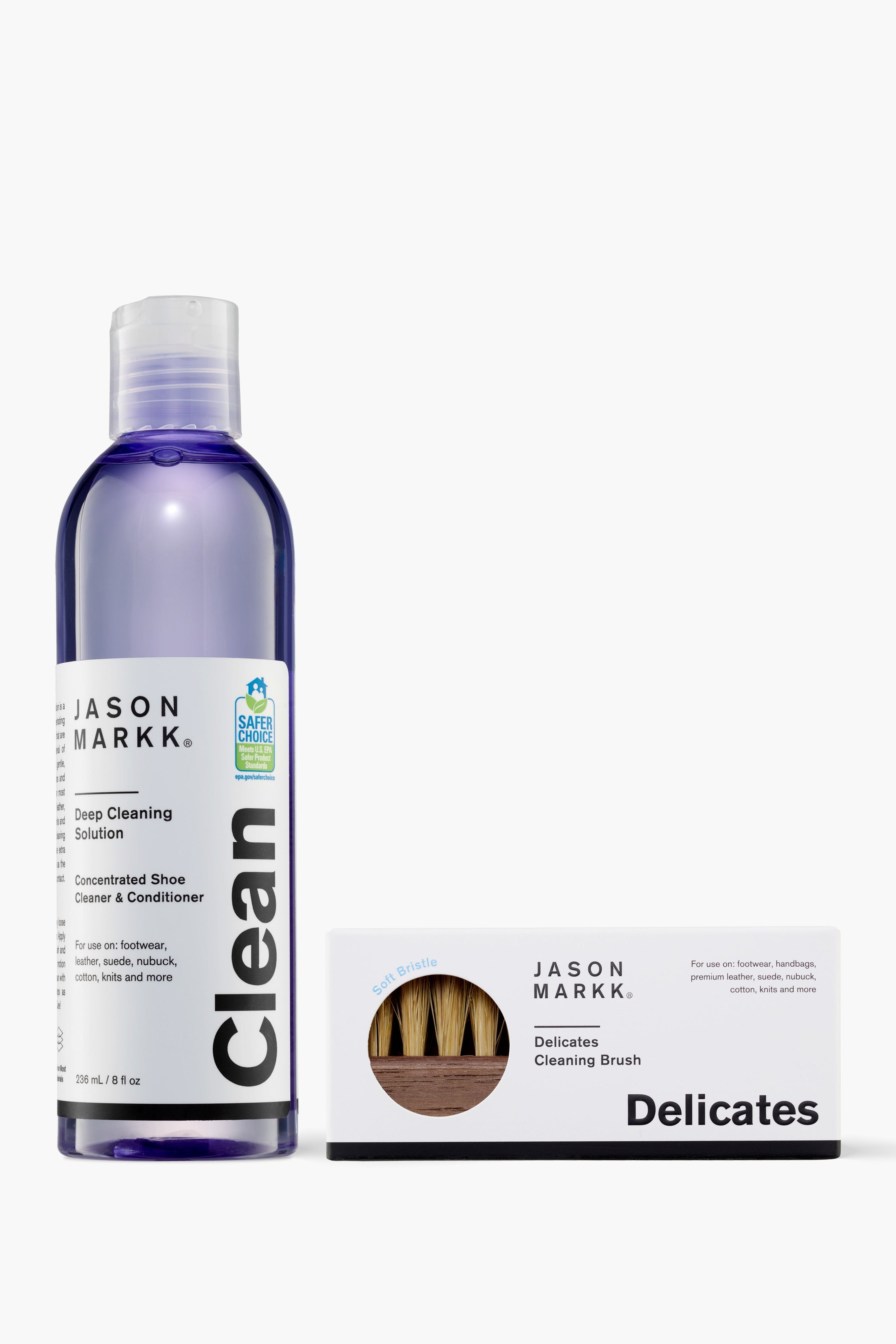 Bottle of Jason Markk shoe cleaning solution with a brush on a white background