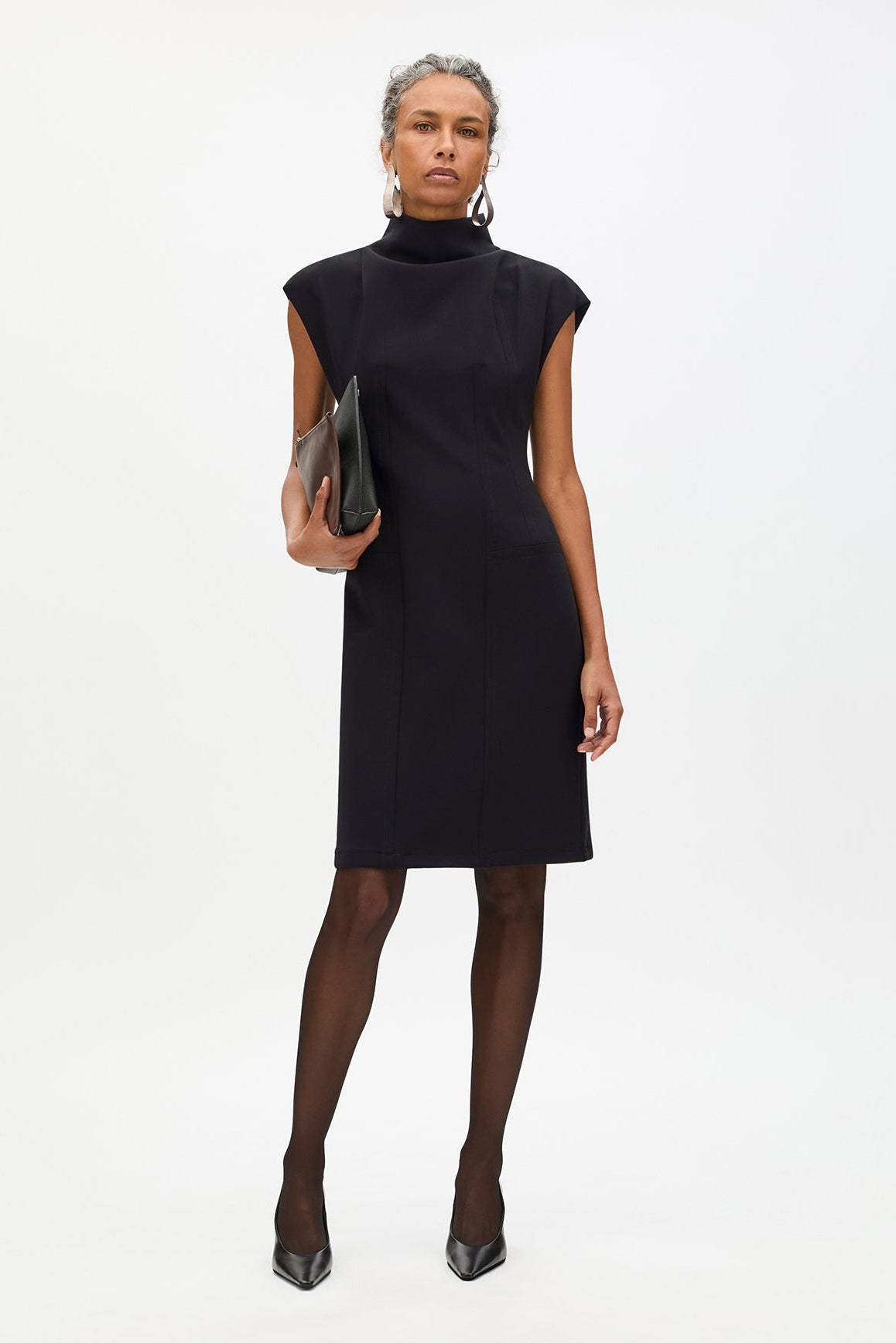 Woman wearing a black dress on a white background