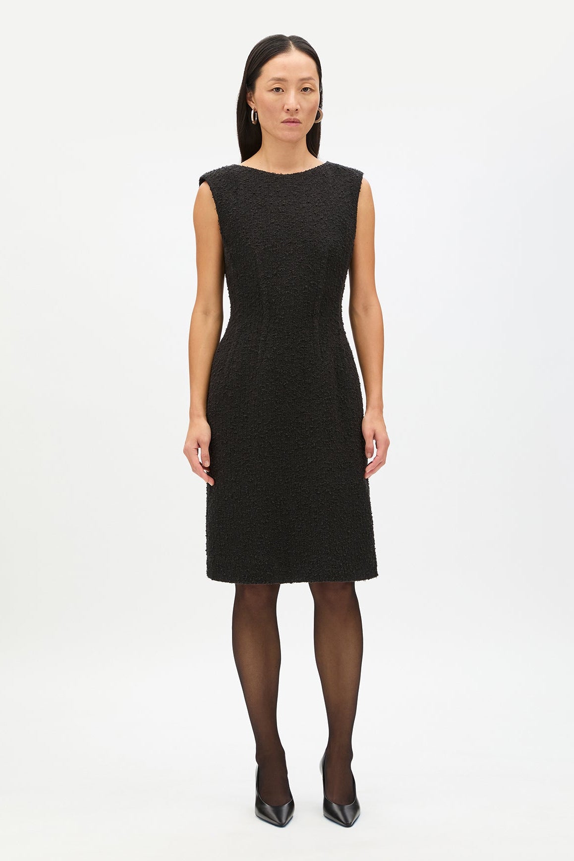 Woman wearing a black dress on a white background