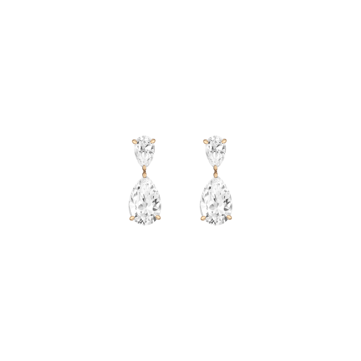 Pair of teardrop-shaped earrings with clear stones on a green background