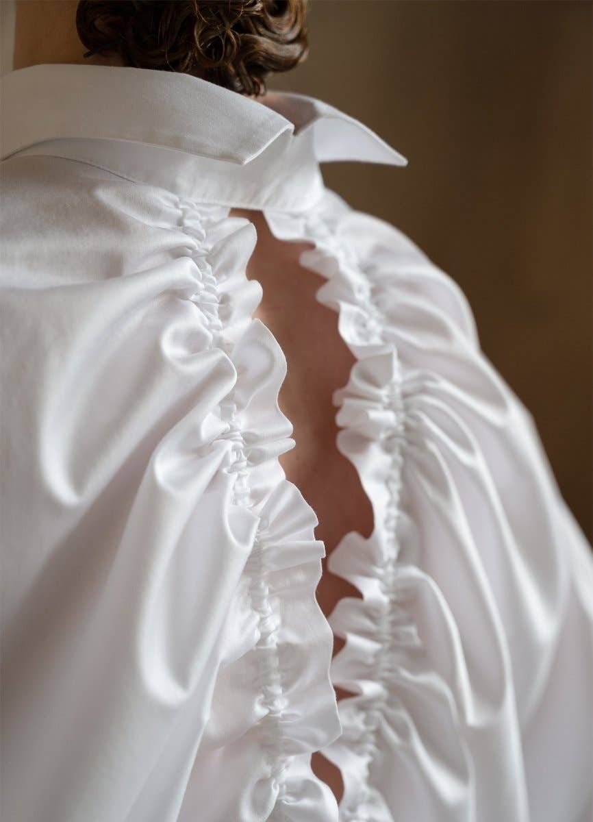 Close-up of a white wedding dress with a blurred background