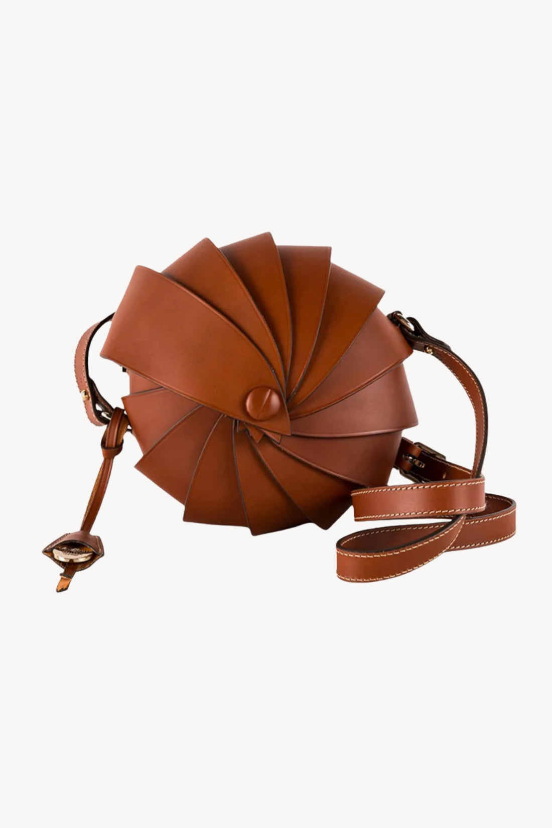Brown leather handbag with a unique nautilus shell-like design on a white background.