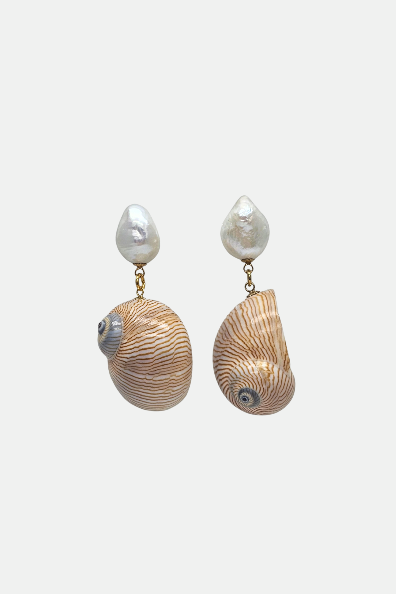 Shell and pearl earrings on a white background