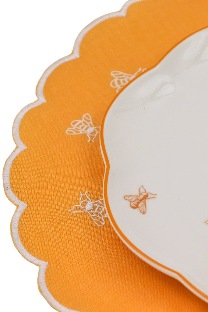 Orange and white fabric with embroidered bee patterns
