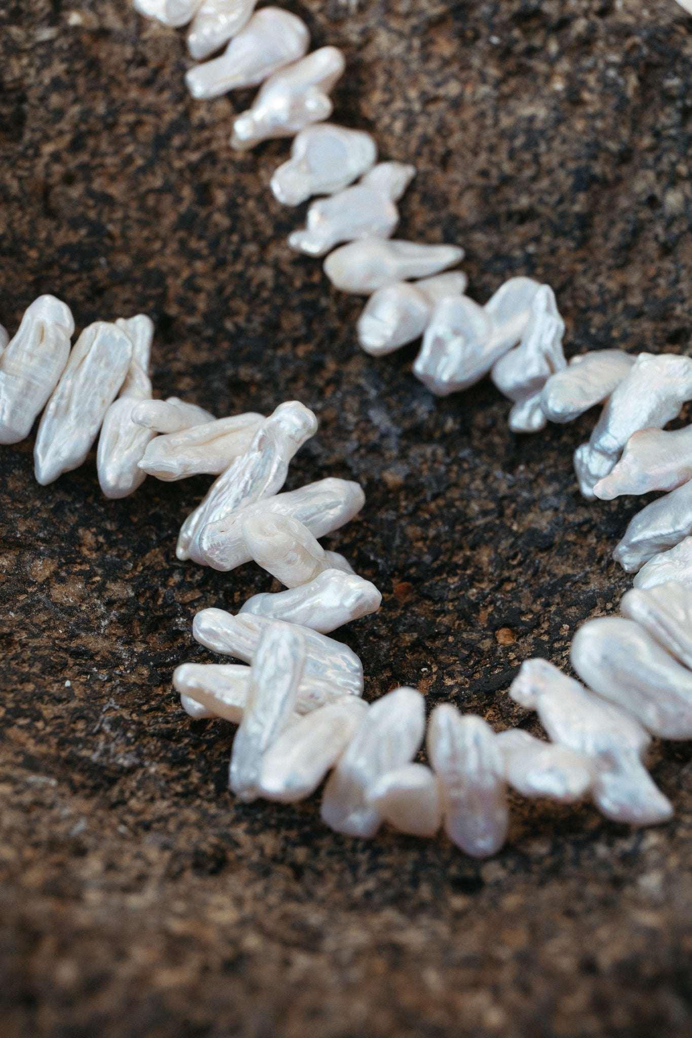 Pearl necklace on a dark textured surface