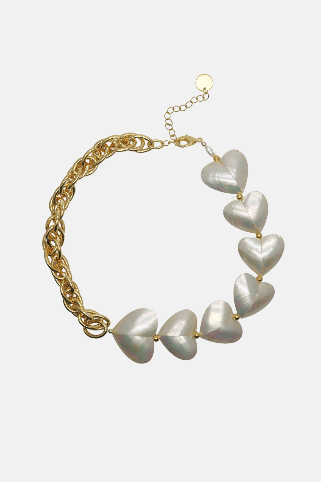 Necklace with heart-shaped pearls on a gold chain against a white background