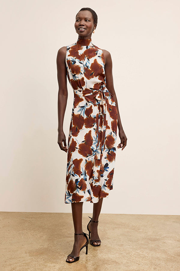 Woman wearing a floral dress with a plain background | Exclude