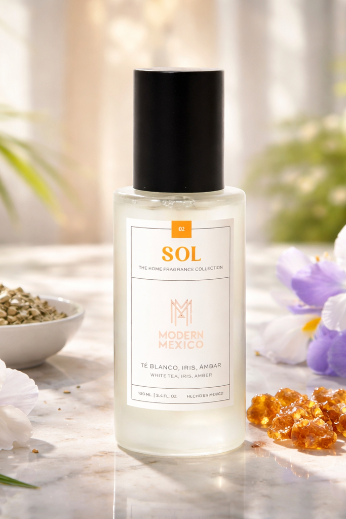Bottle of SOL home fragrance by Modern Mexico with flowers and amber on a wooden surface