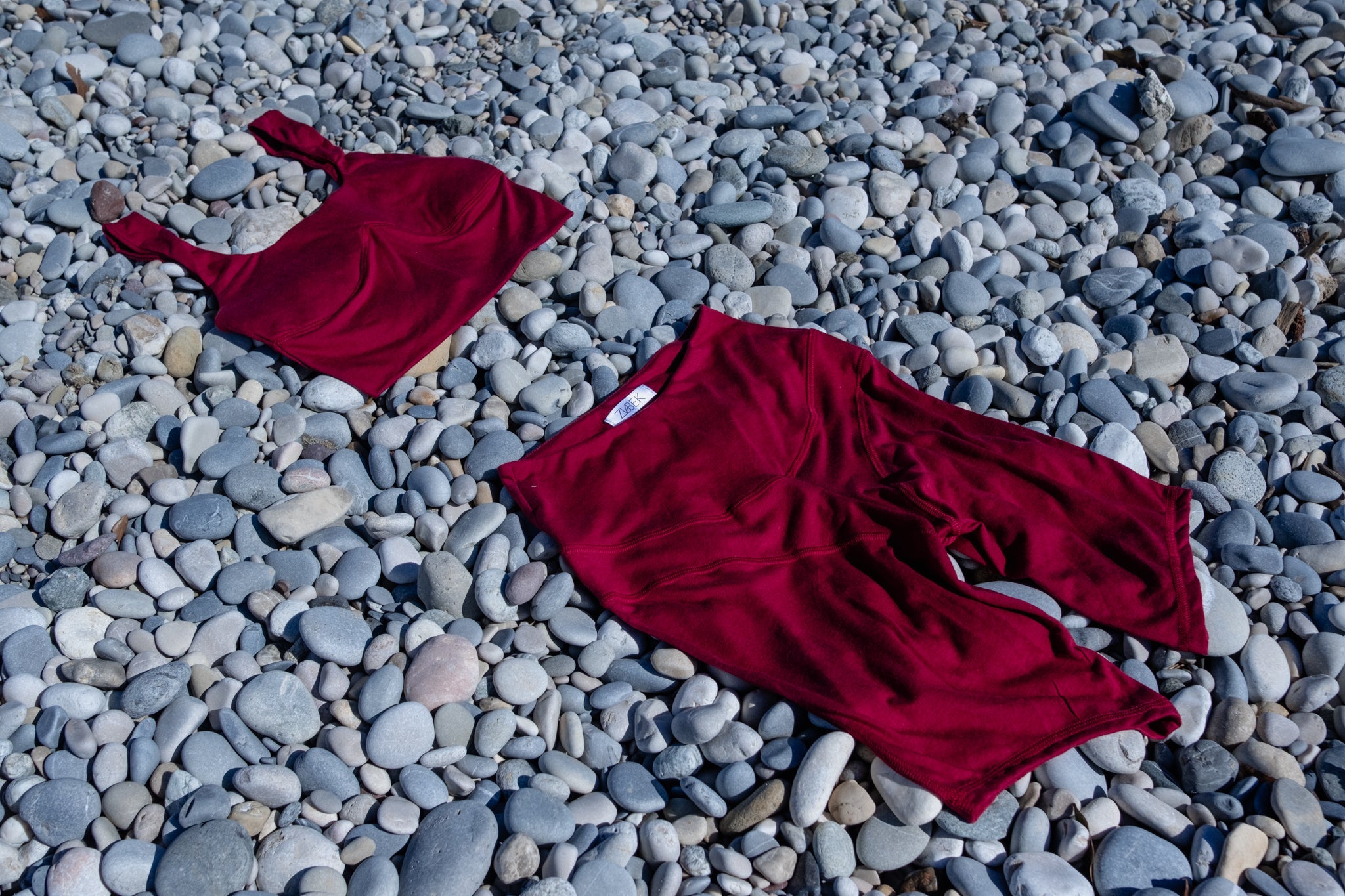 Red outfit on pebbles