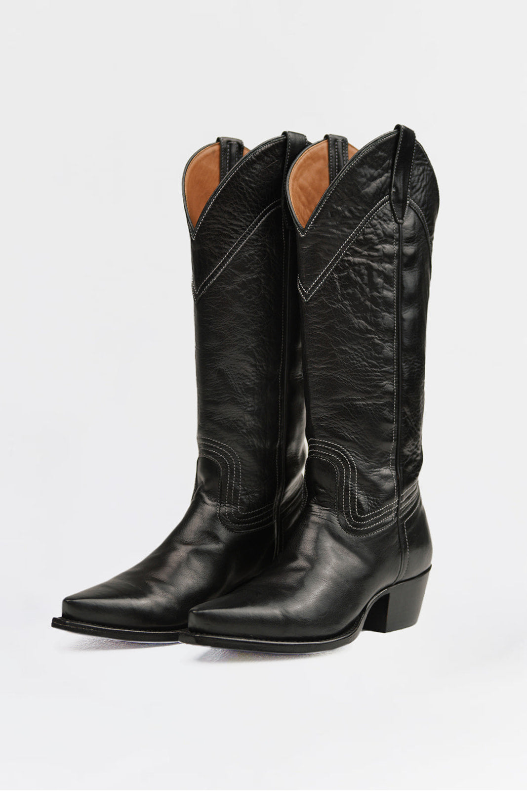 A pair of black leather cowboy boots with pointed toes and low block heels, shown from a three-quarter angle against a plain white background.