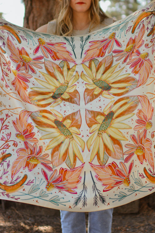 Person holding a floral patterned fabric outdoors