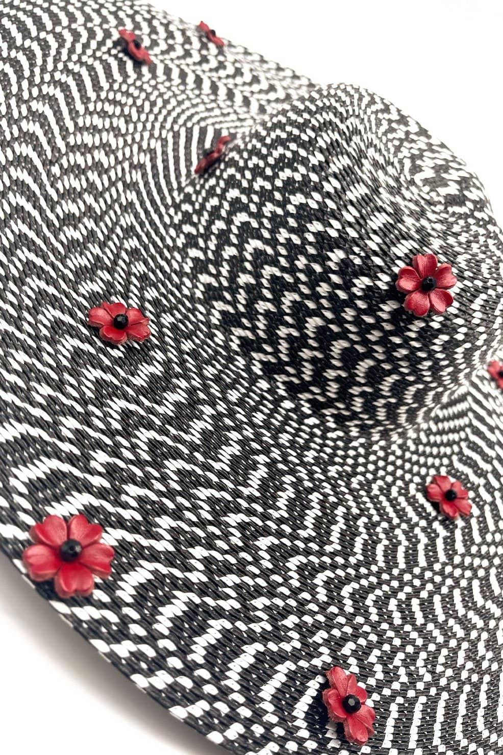 Black and white patterned tie with red floral accents on a white background