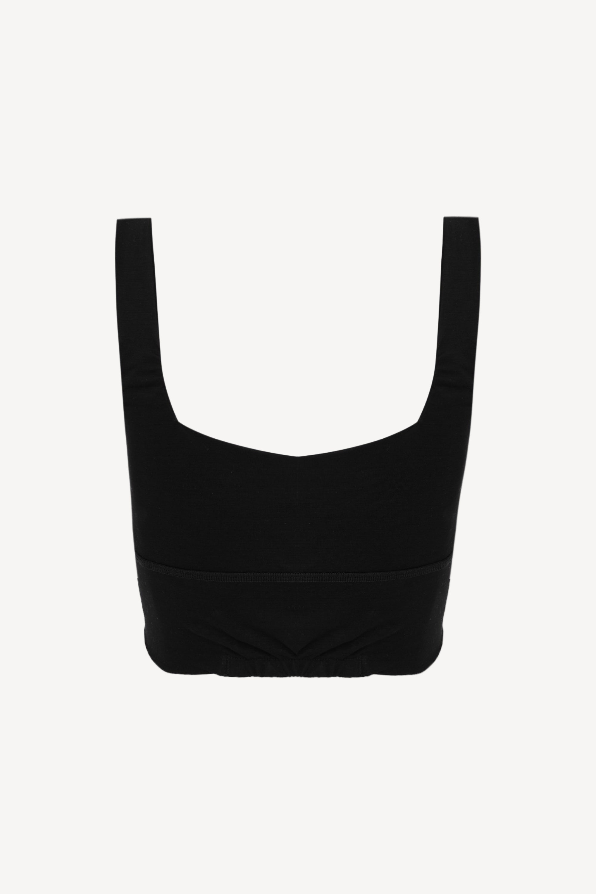 Black crop top on a light beige background