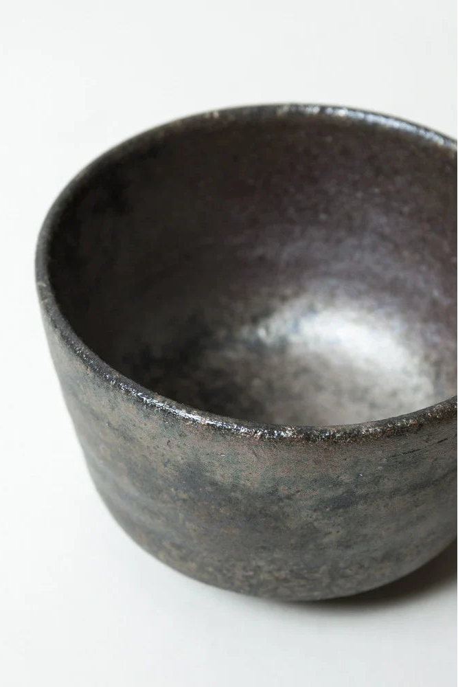 Dark ceramic bowl on a white background