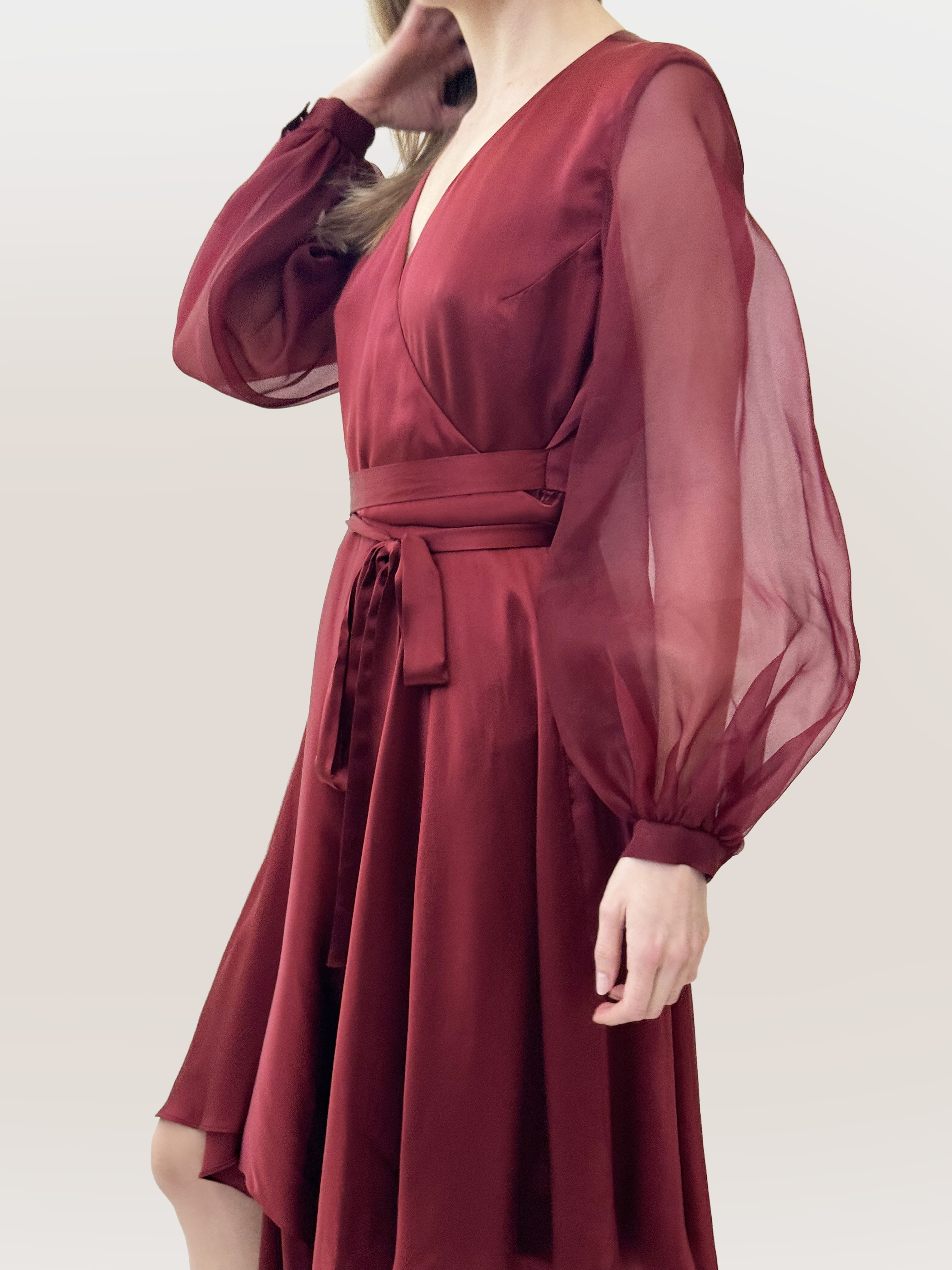 Red dress with sheer sleeves on a plain background