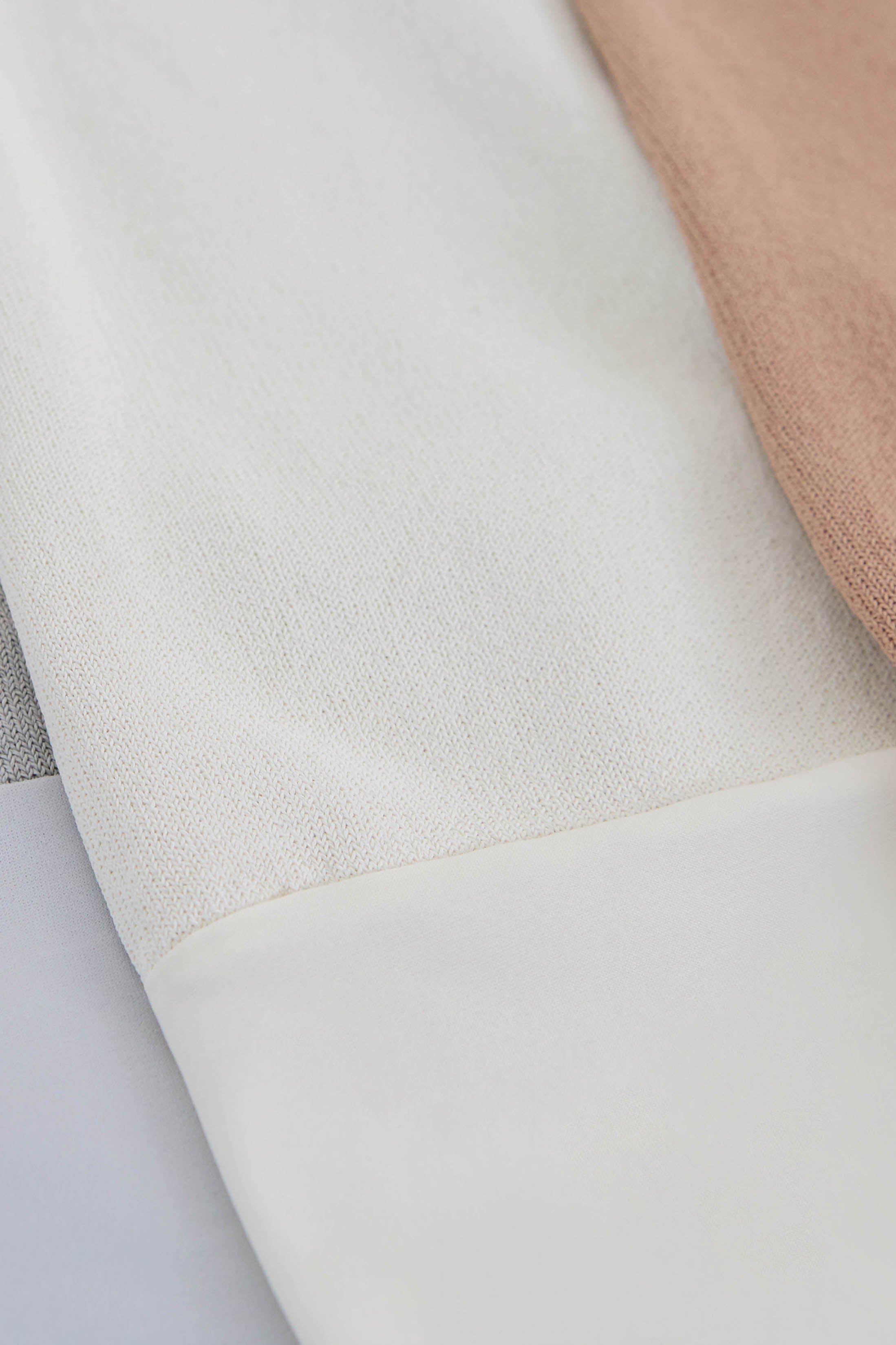 Close-up of fabric with a textured pattern on a light gray background