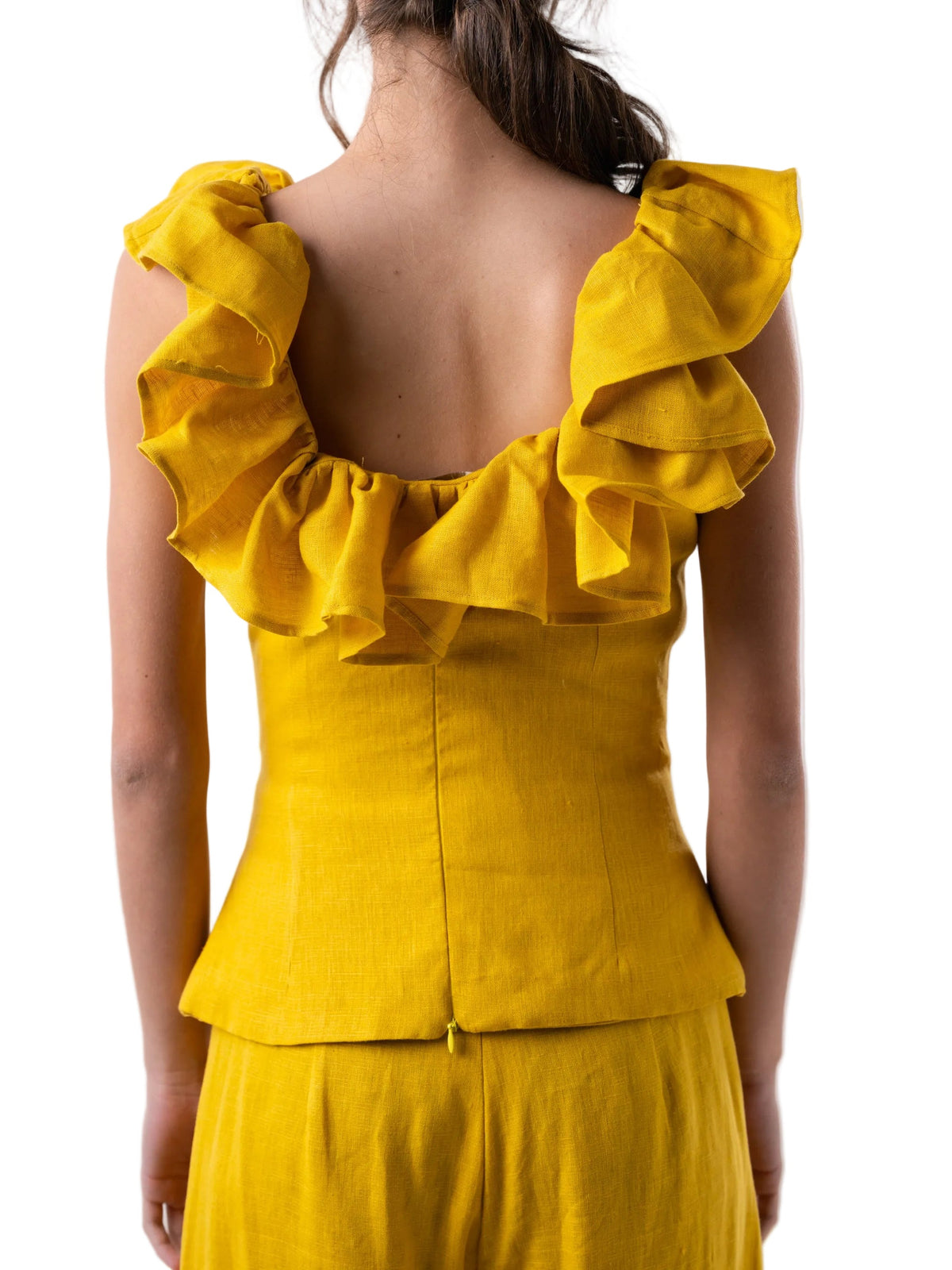 Yellow top with ruffled shoulders on a white background