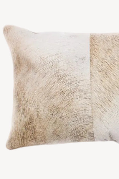 Beige cowhide pillow with a natural pattern on a white background