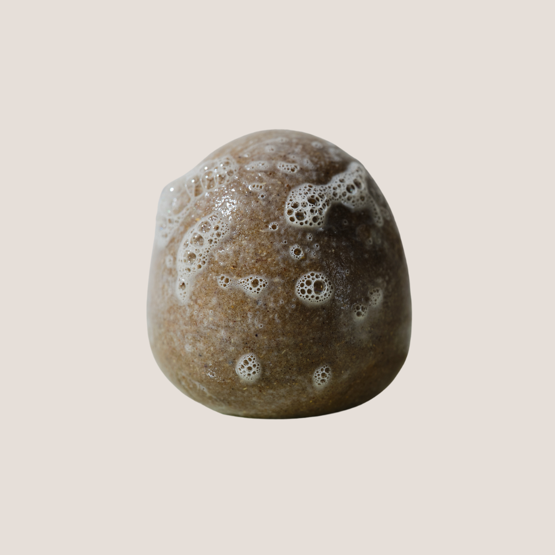Brown shampoo stone with bubble texture on a beige background