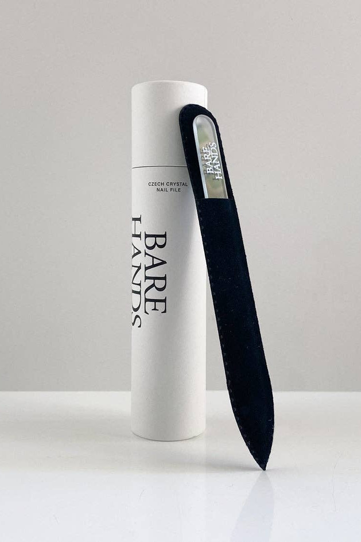 White cylindrical container with a black nail file labeled 'Bare Hands' on a light gray background