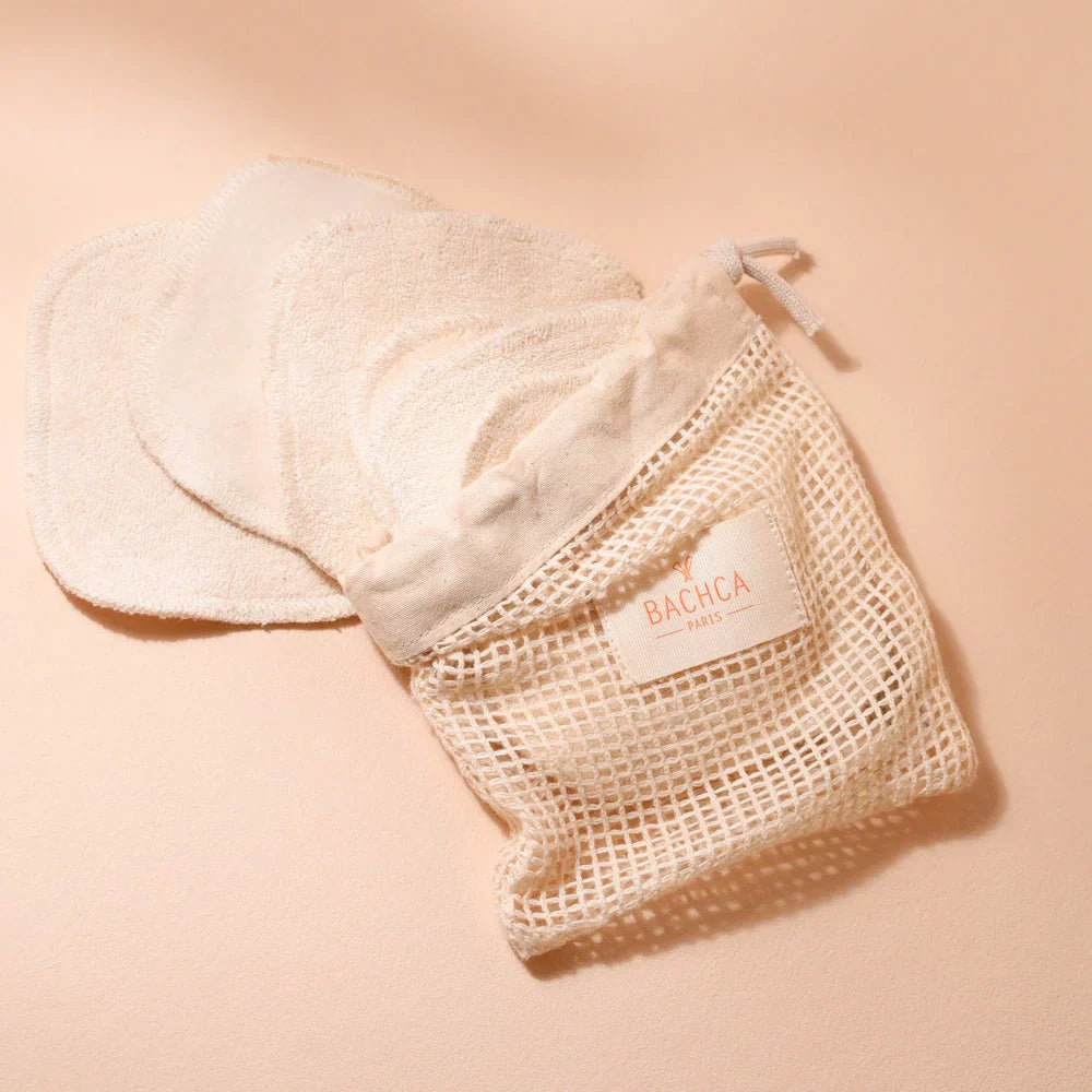 Cotton pads with a mesh bag on a beige background, featuring the brand 'BACHA'.