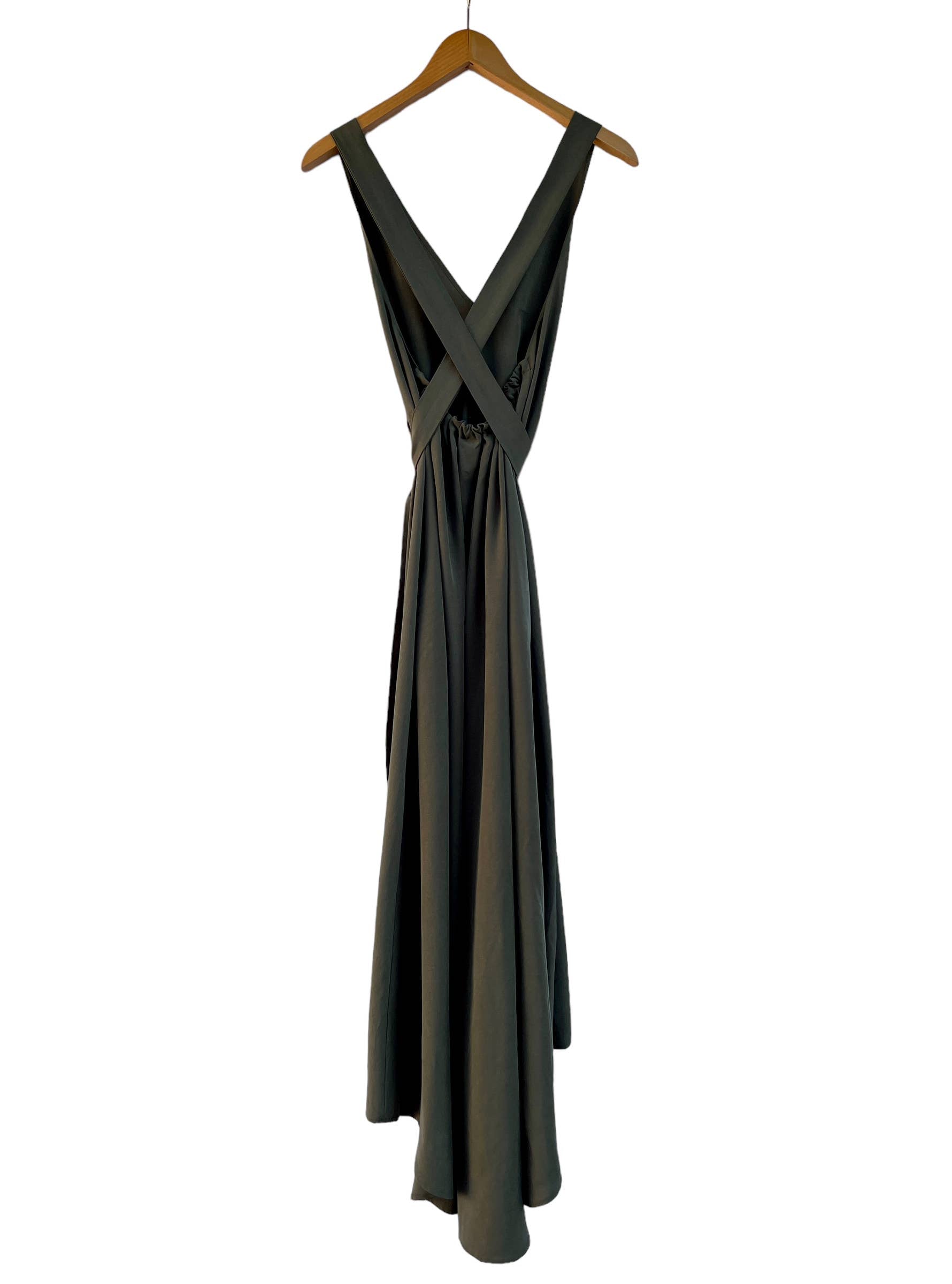 The back of an olive green dress on a wooden hanger against a white background.