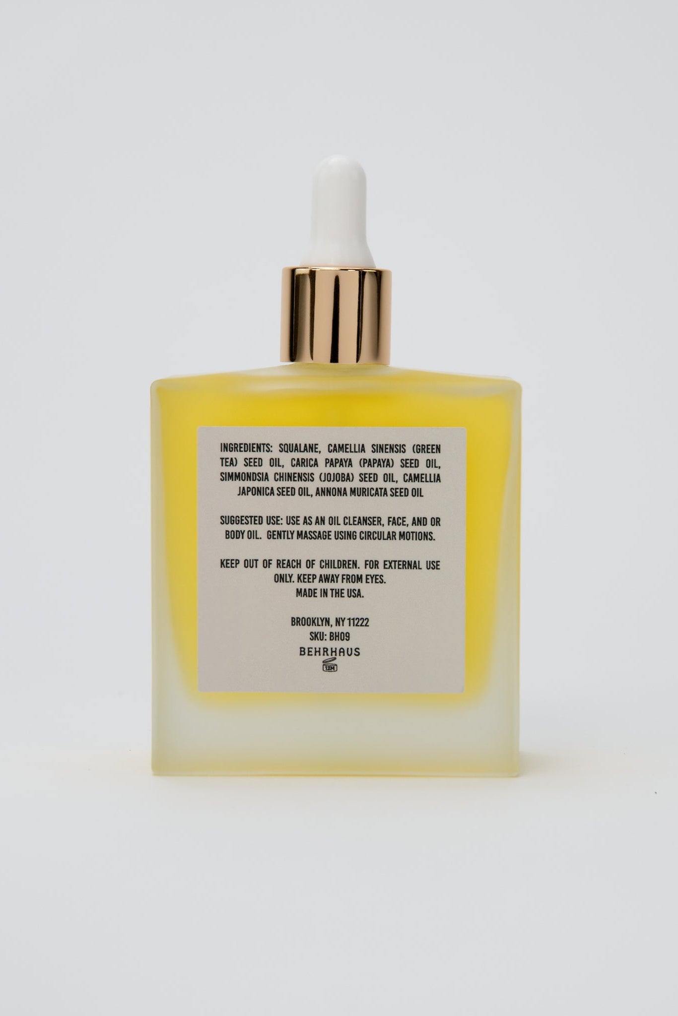 Yellow skincare bottle with dropper on a white background