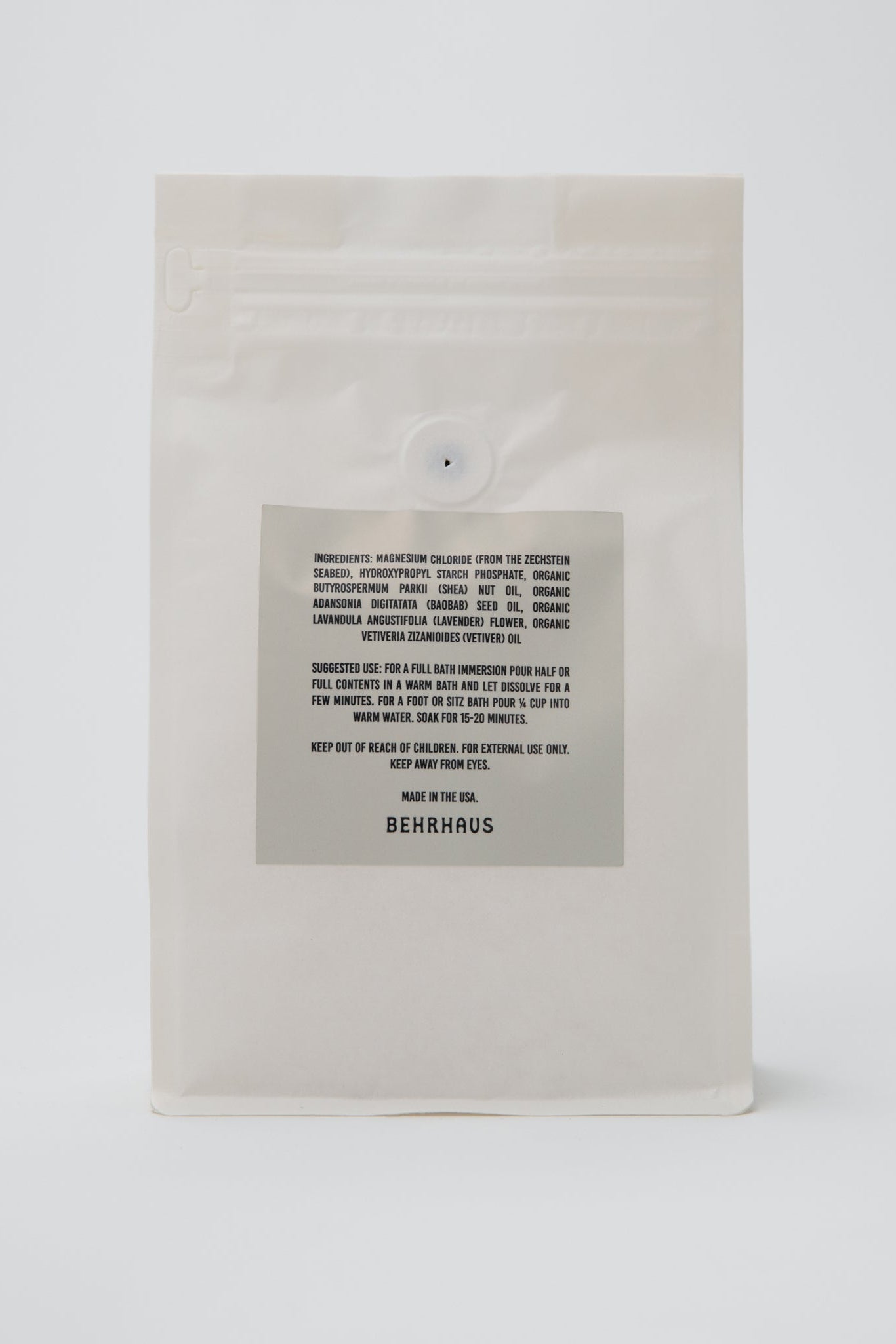 Beige product packaging with a label on a white background