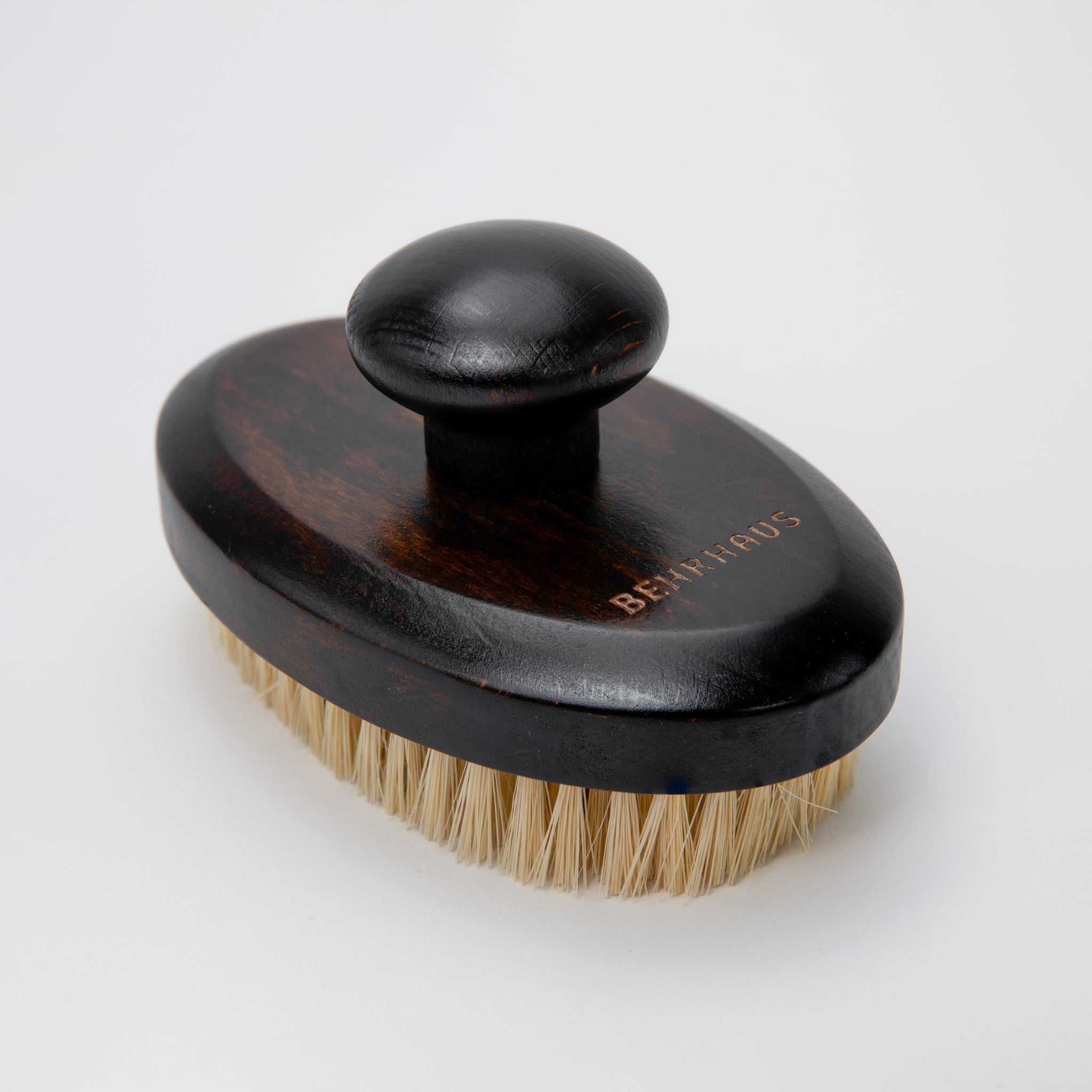 brown-handled brush with bristles on a white background