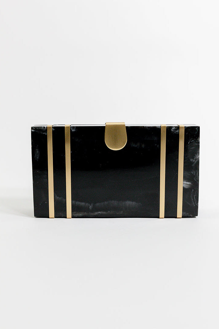 Black clutch with gold stripes and a gold clasp on a white background