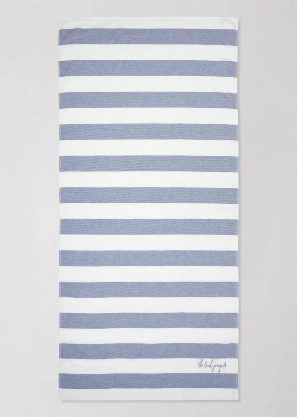 Striped towel with blue and white stripes on a gray background