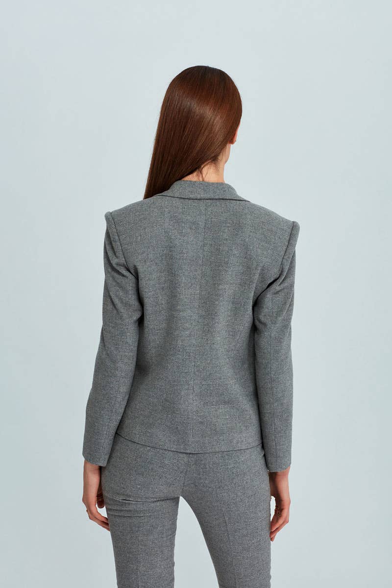Person wearing a gray suit on a light gray background