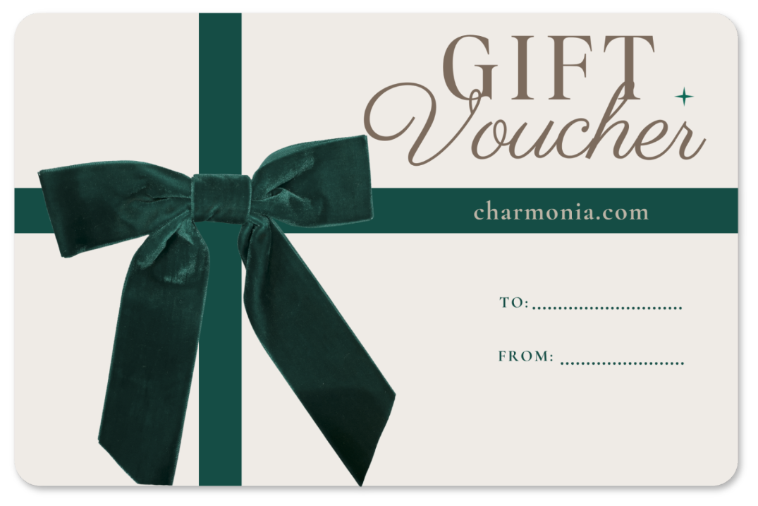 Gift voucher for Charmonia fashion with a green bow on a white background, featuring the brand 'charmonia.com'.