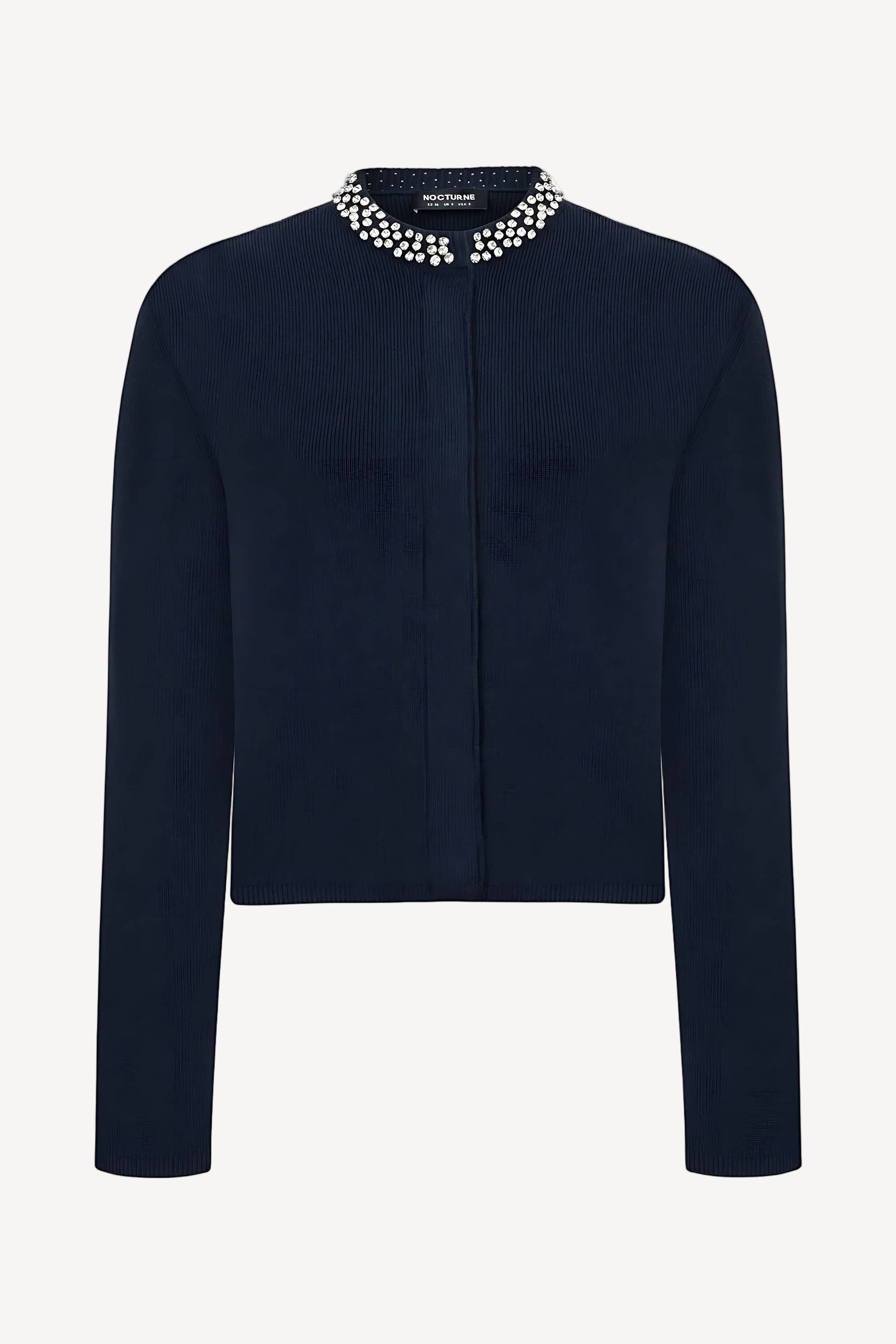 A navy blue cardigan with shiny stone appliques on the collar, half-turtleneck, long sleeves, and a hidden snap closure.