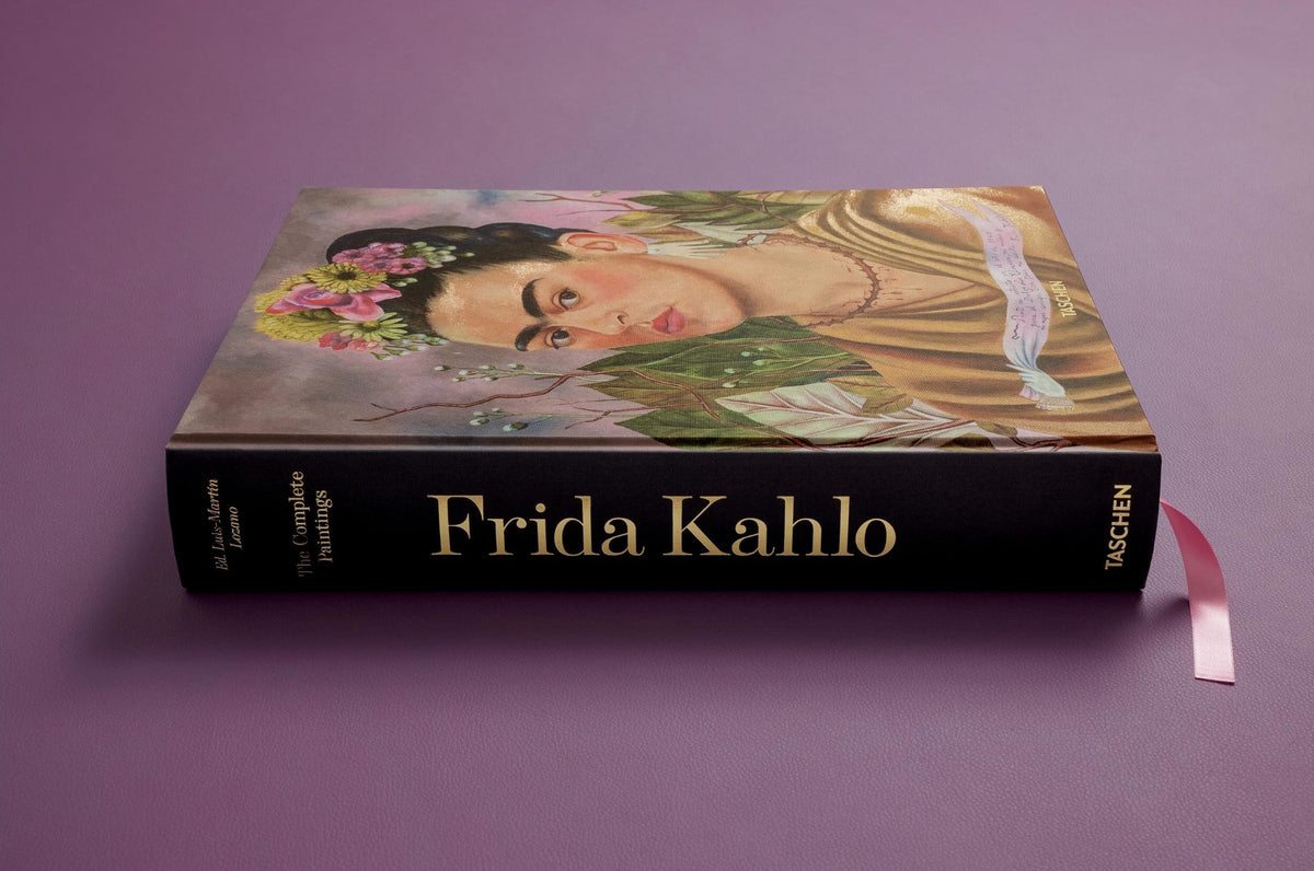 Book titled 'Frida Kahlo' with a portrait of the artist on the cover against a purple background