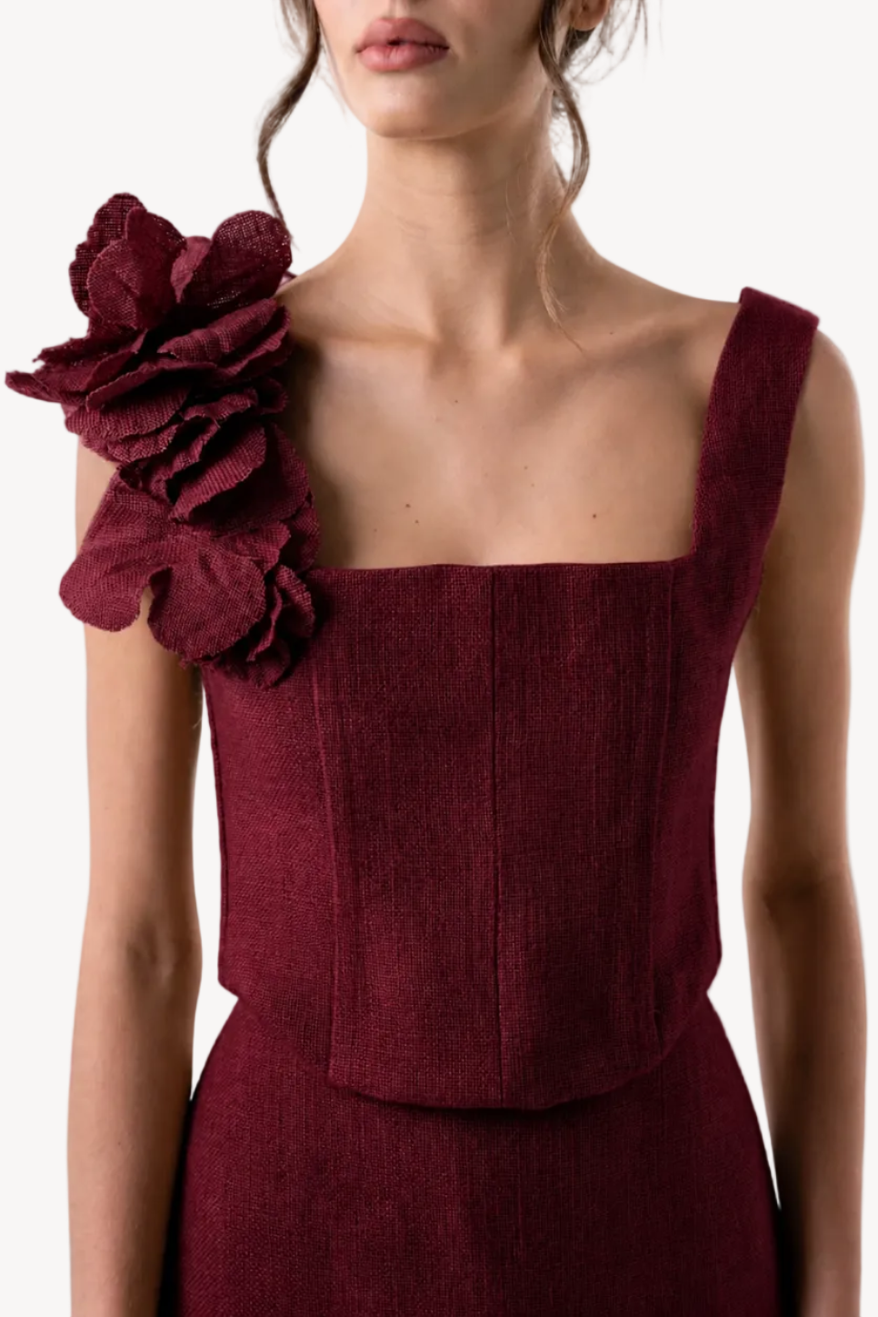 Maroon top with floral detail on a white background