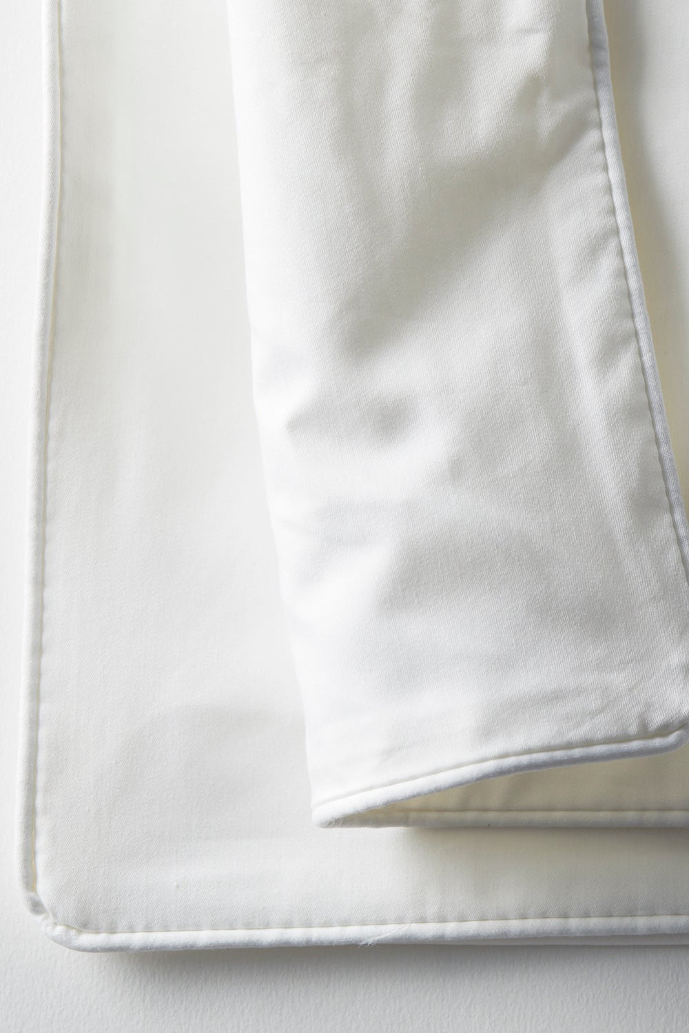White satin fabric on a light gray background