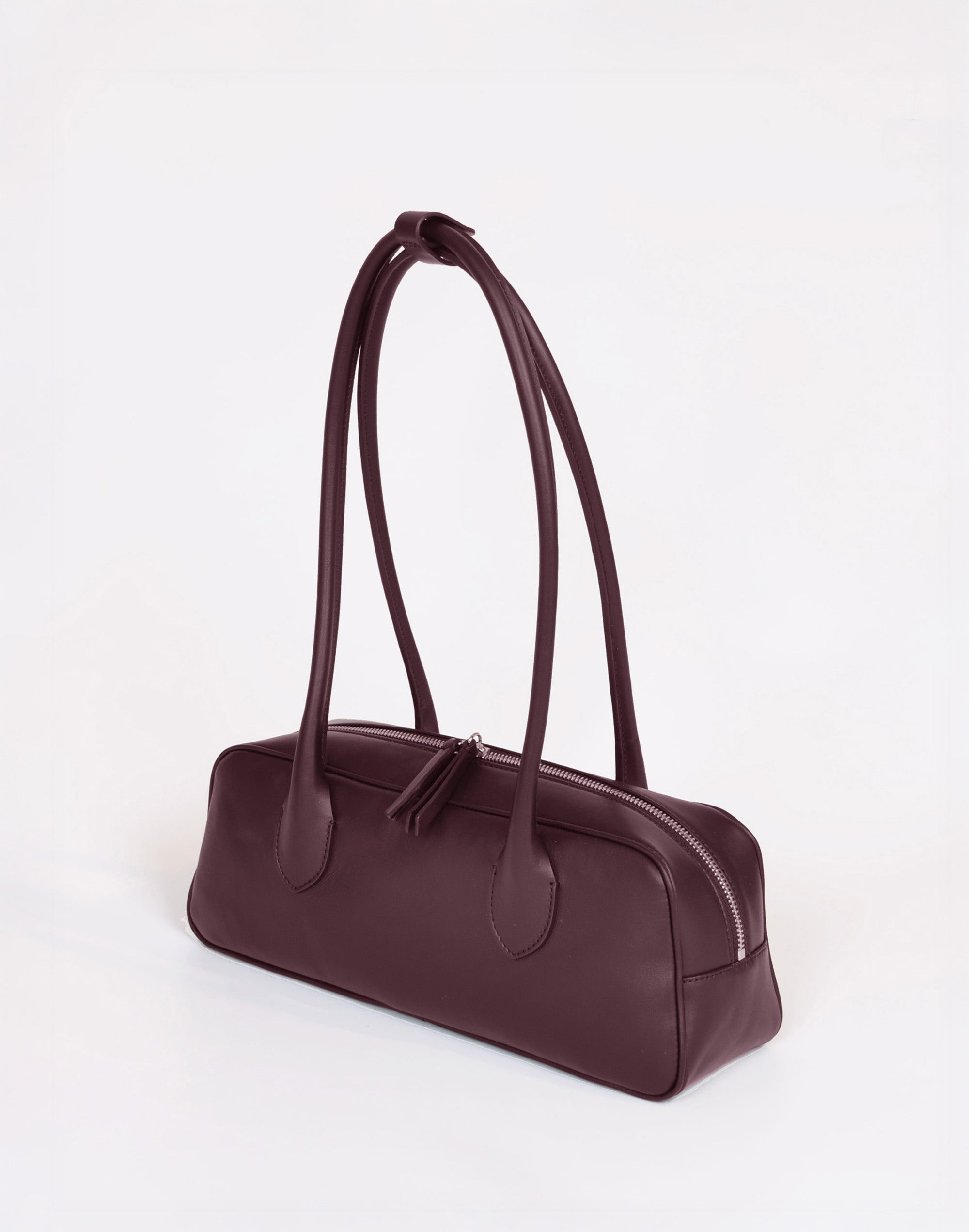 Brown handbag with a strap on a white background