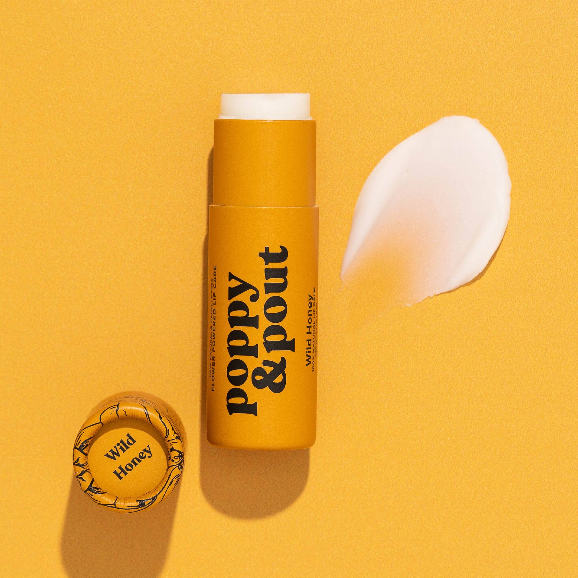 Yellow lip balm stick with 'Poppy & Pout' branding on a yellow background