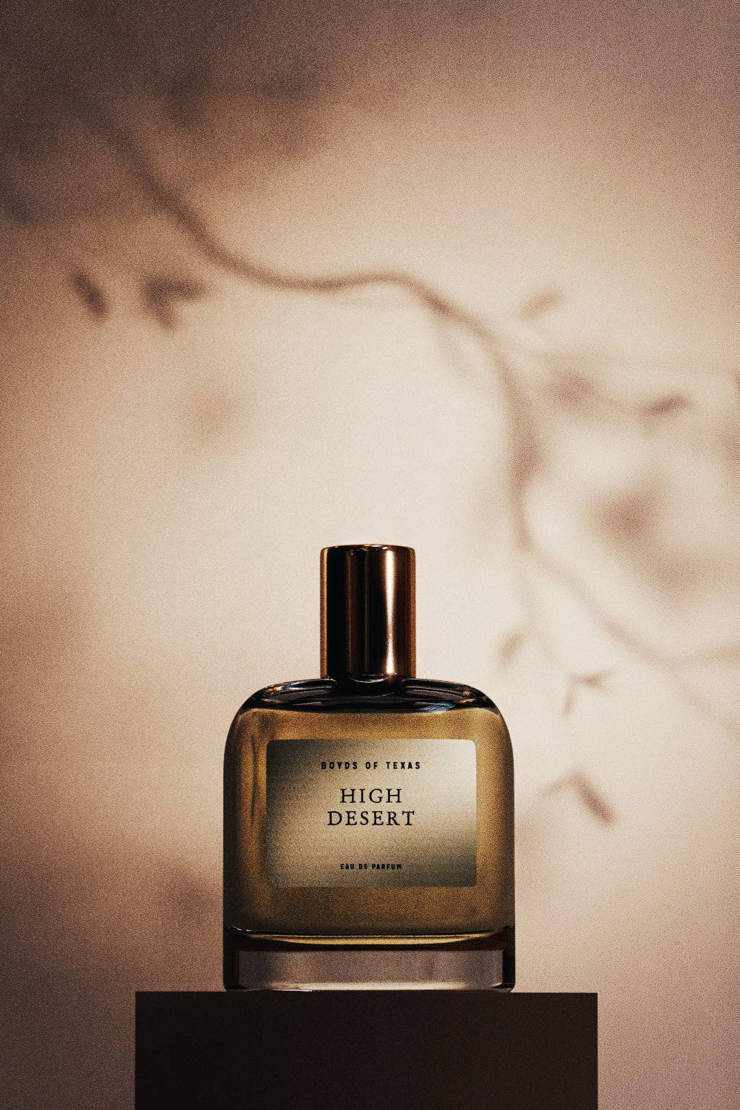 Perfume bottle labeled 'High Desert' on a neutral background