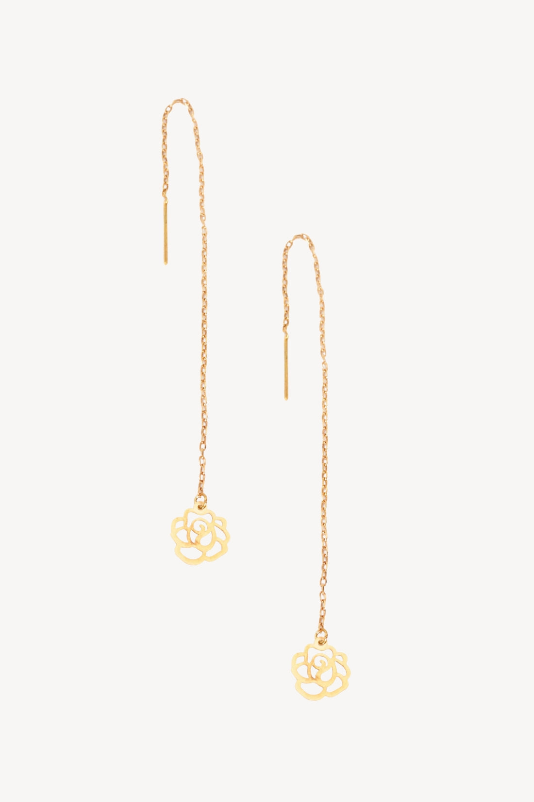 Gold chain earrings with floral ends on a white background