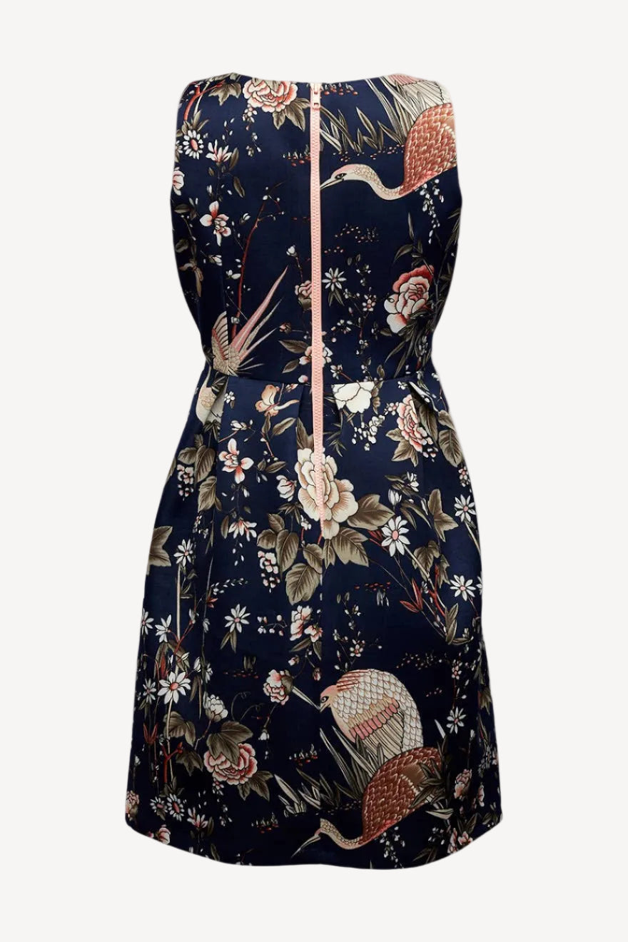 Floral and bird patterned dress on a white background